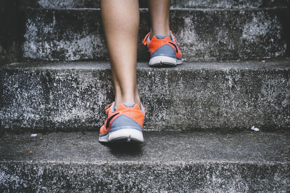 A person walking outdoors in athletic shoes