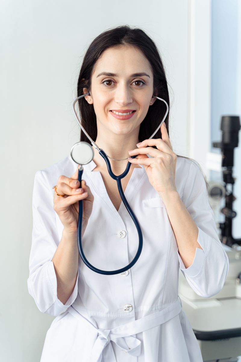 Amira Solano, a clinician in a white coat holding a stethoscope
